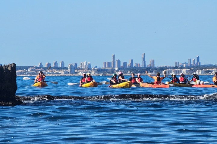 a group of people on a boat in the water