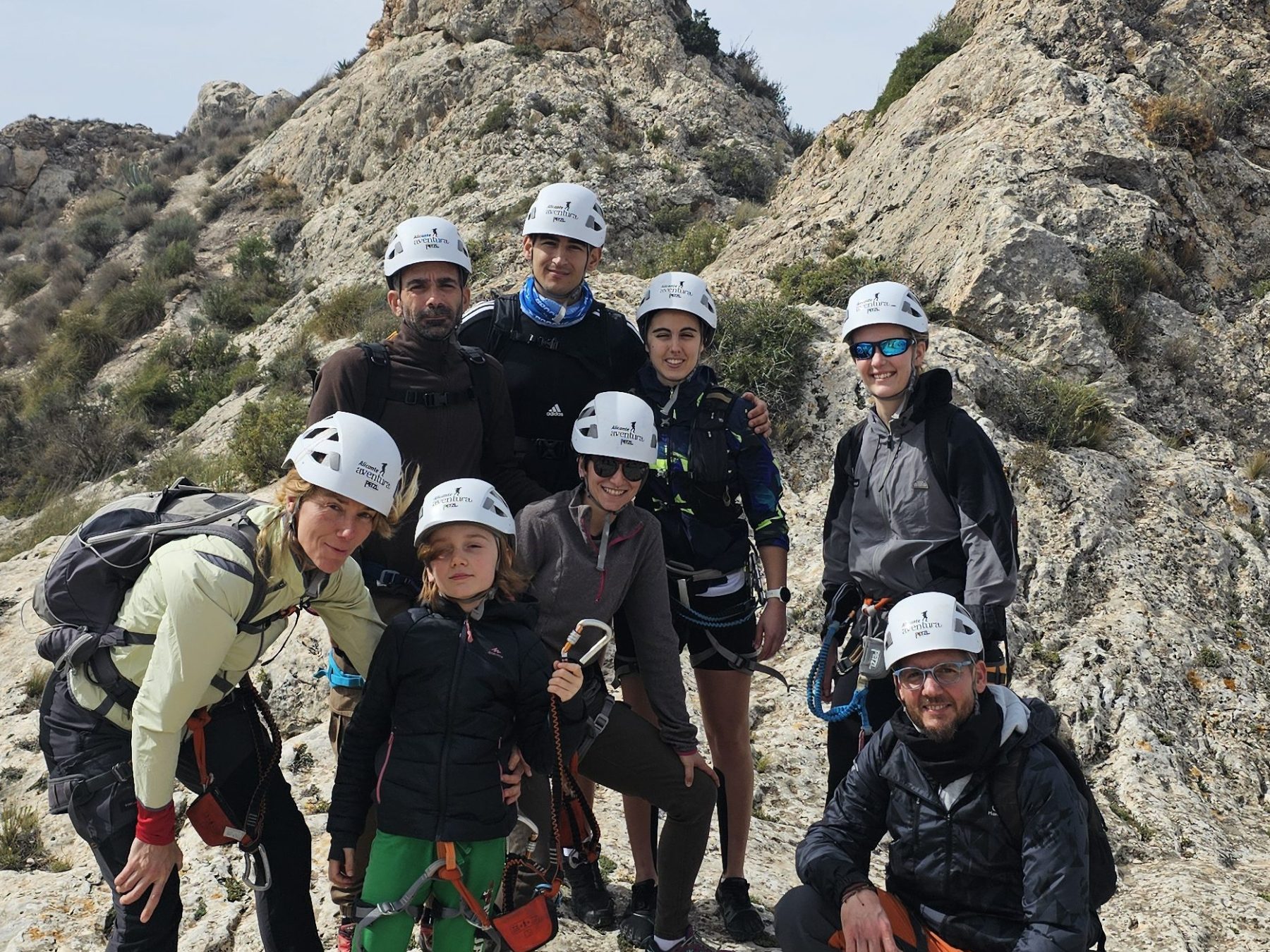 a group of people standing in a rocky area