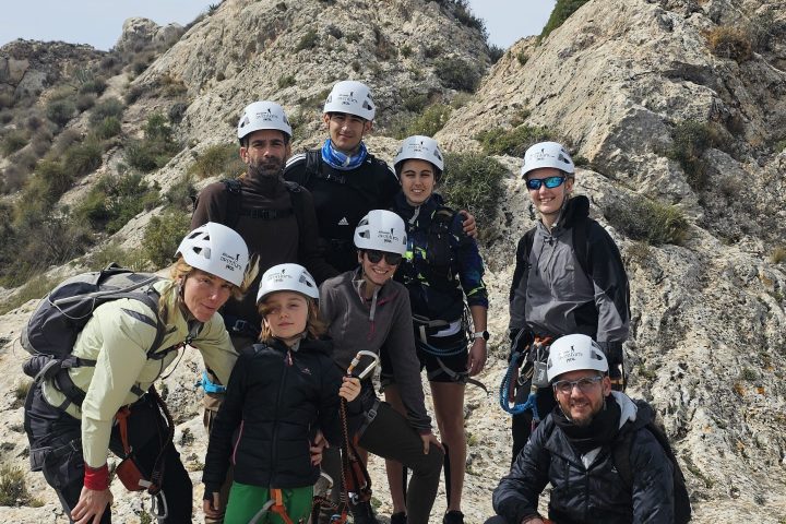 a group of people standing in a rocky area