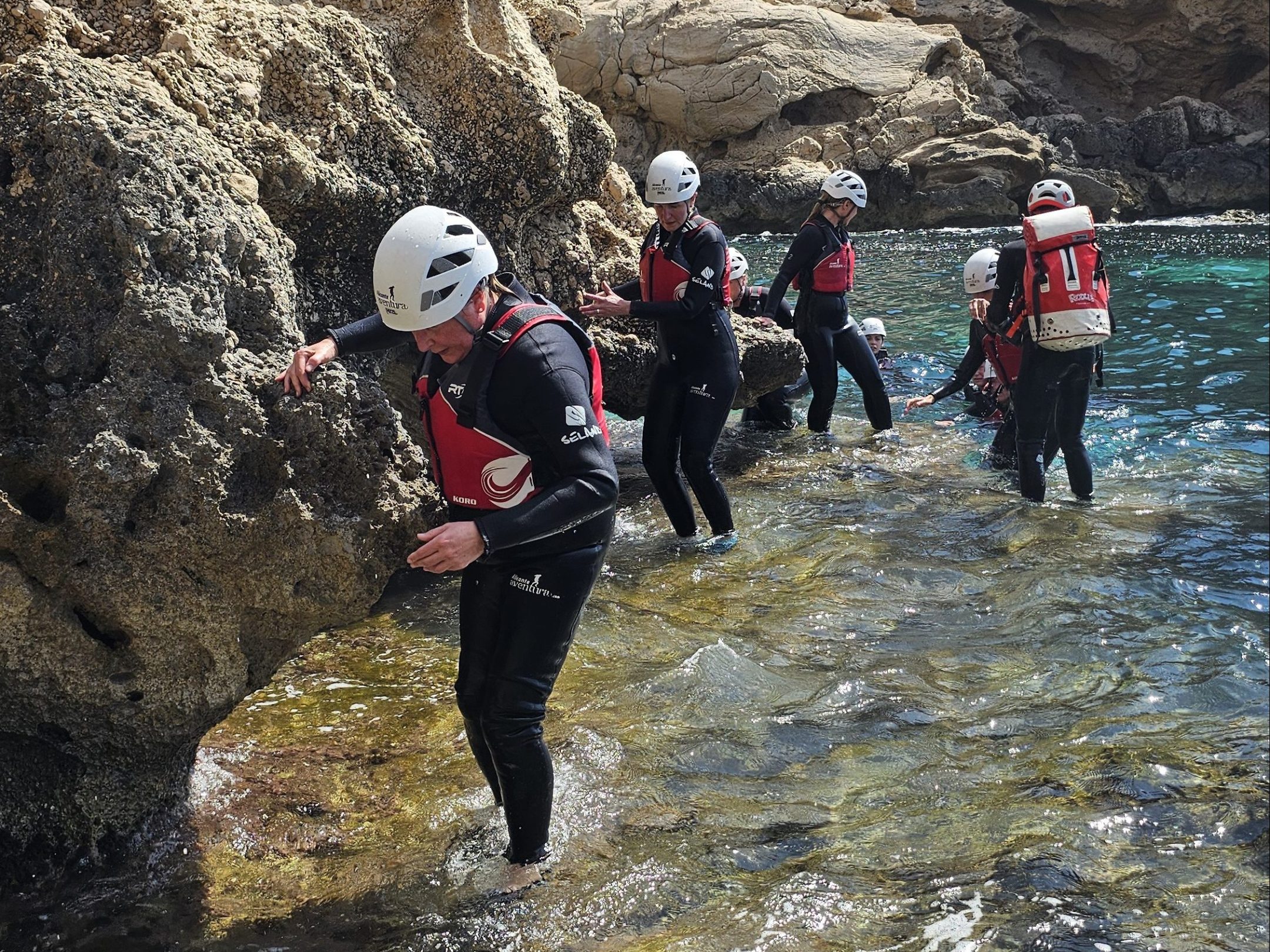 a group of people on a rocky hill
