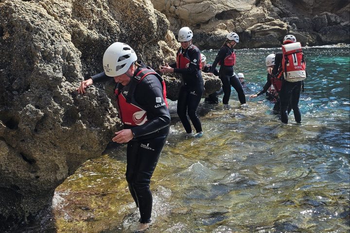 a group of people on a rocky hill