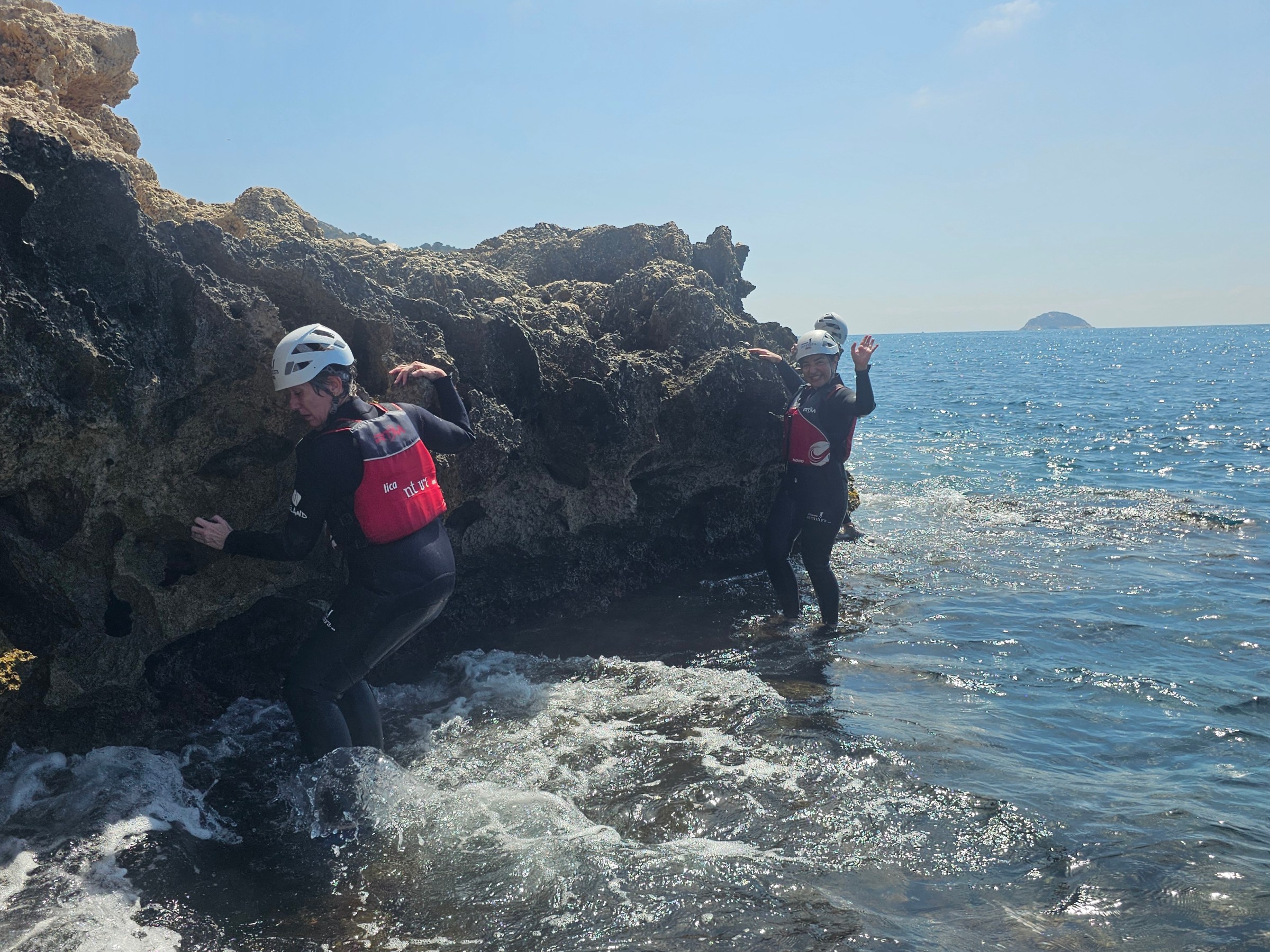 a man swimming in the water with a mountain in the background
