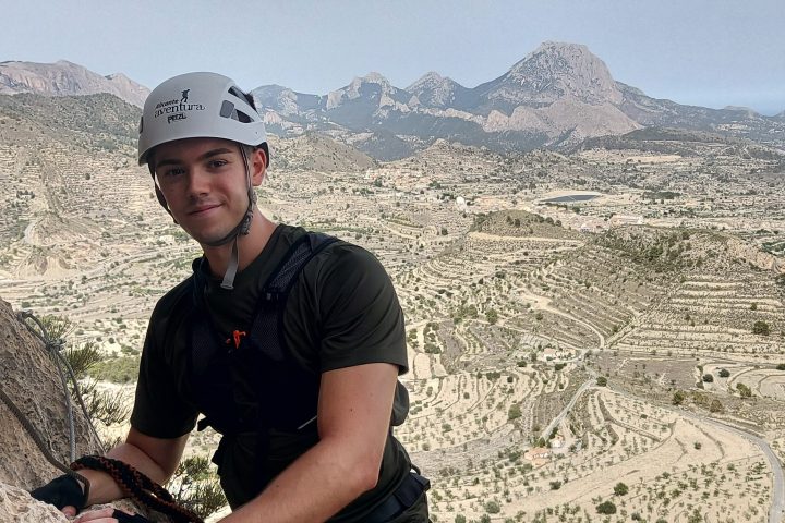 a man standing in front of a mountain