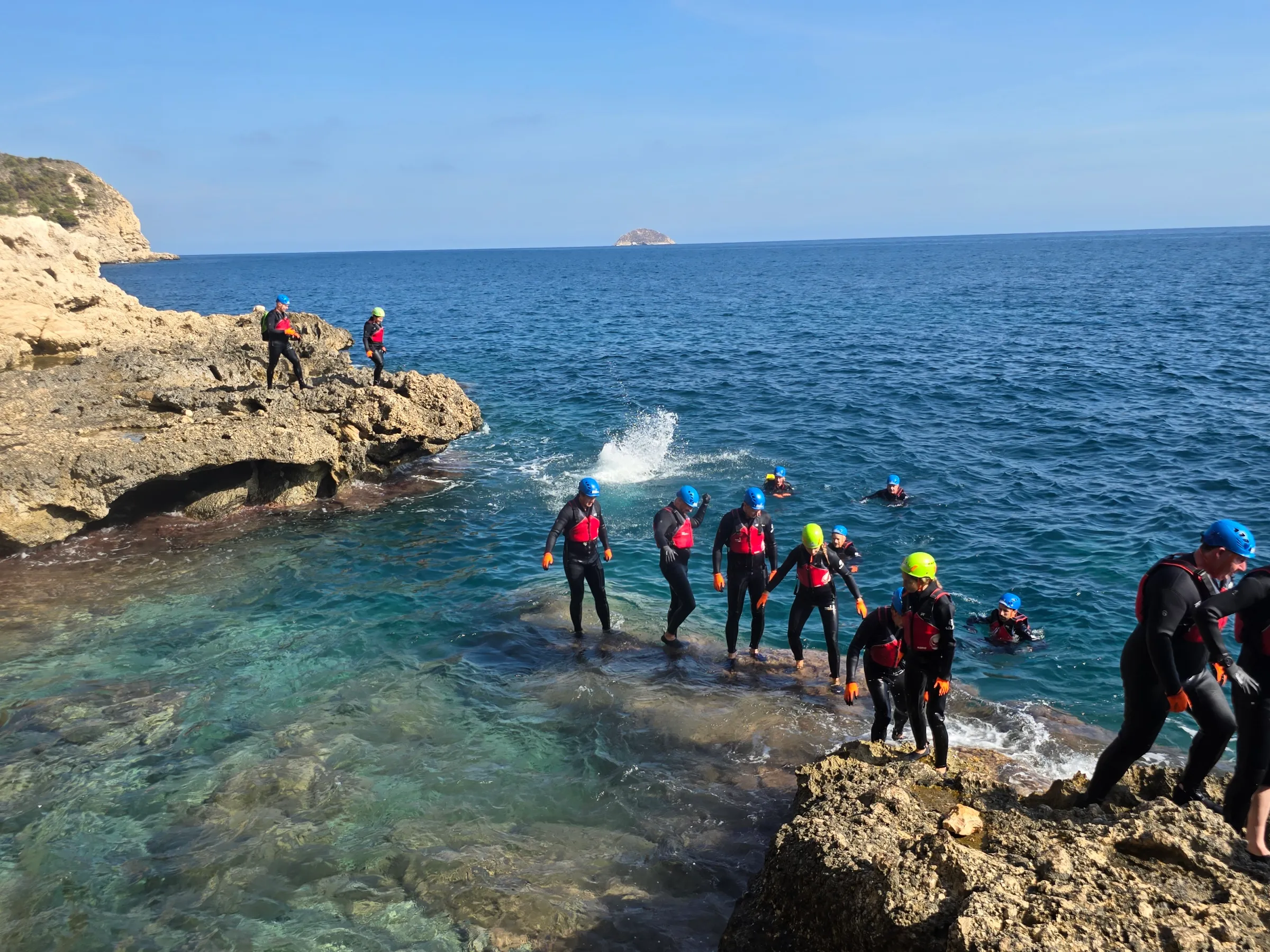 a group of people on a rocky beach