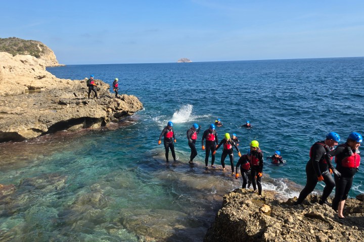 a group of people on a rocky beach
