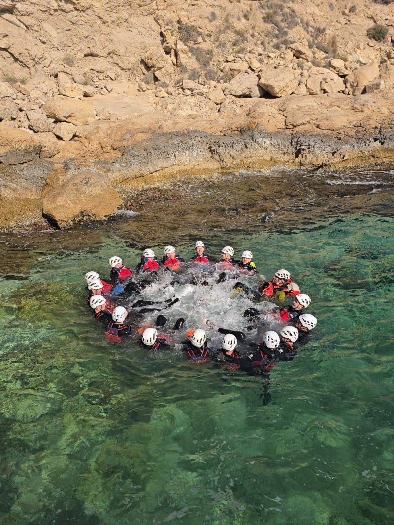 a group of people swimming in the dirt