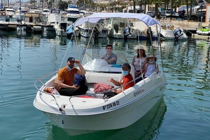 a group of people in a small boat in a body of water