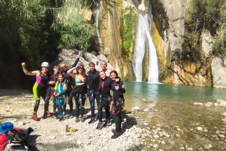 a group of people standing next to a river