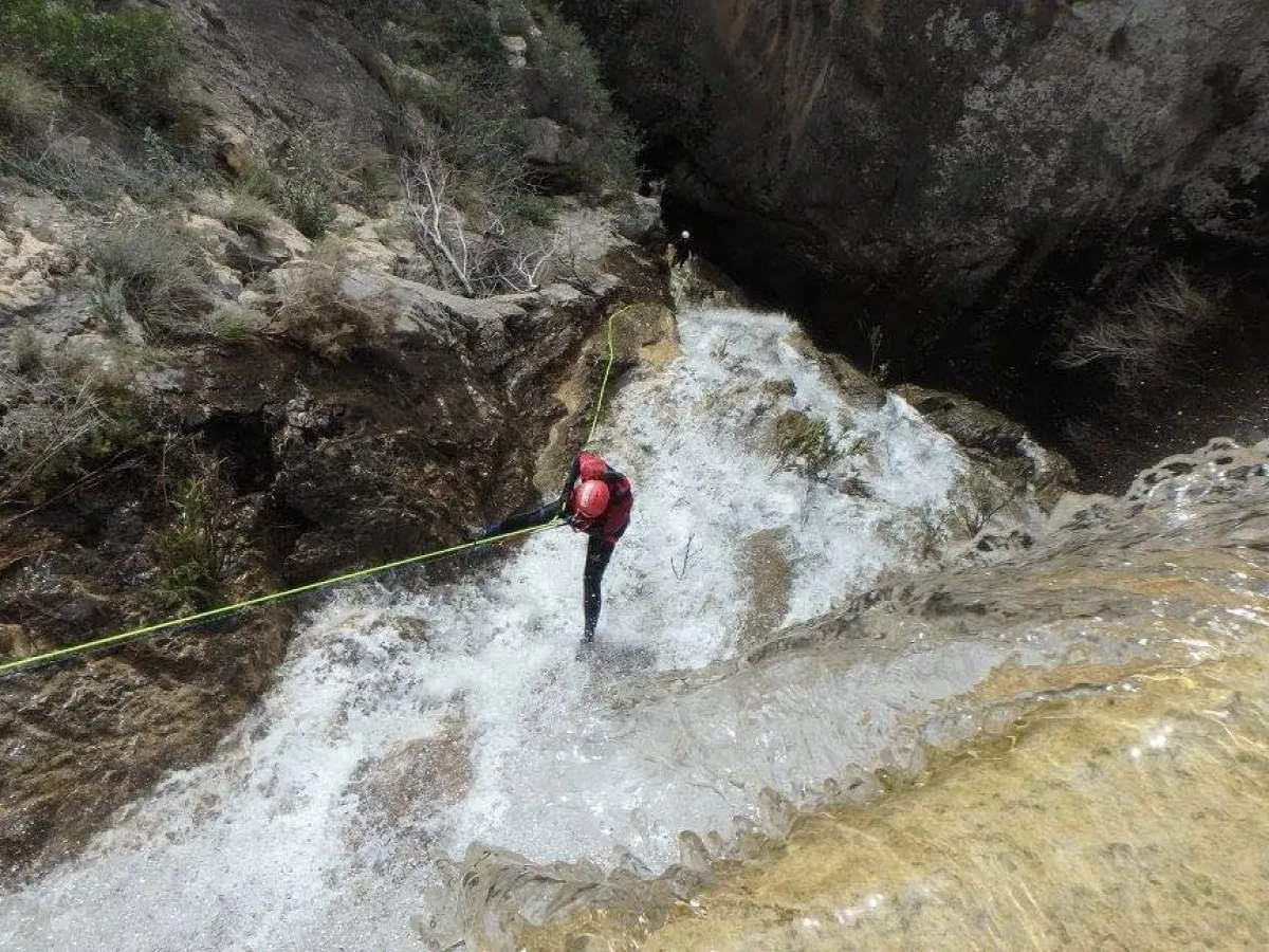 a man riding a wave on top of a rock