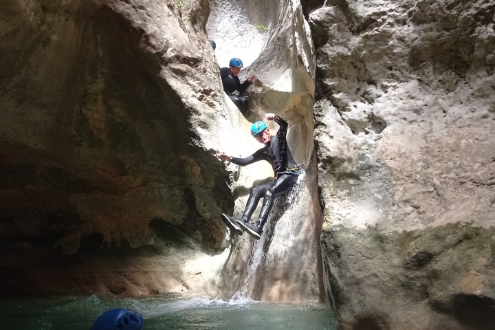 a man riding on the back of a large rock