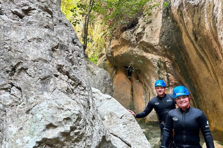 a group of people standing on a rock