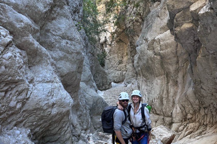 a man standing on a rock in the snow