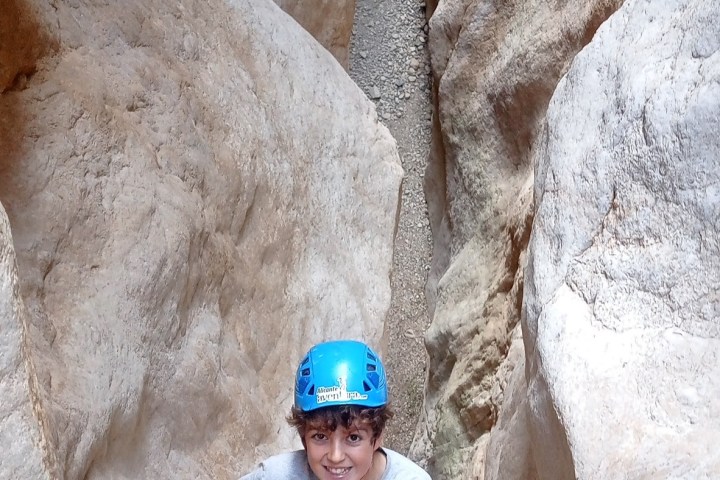a person standing on a rock in the snow
