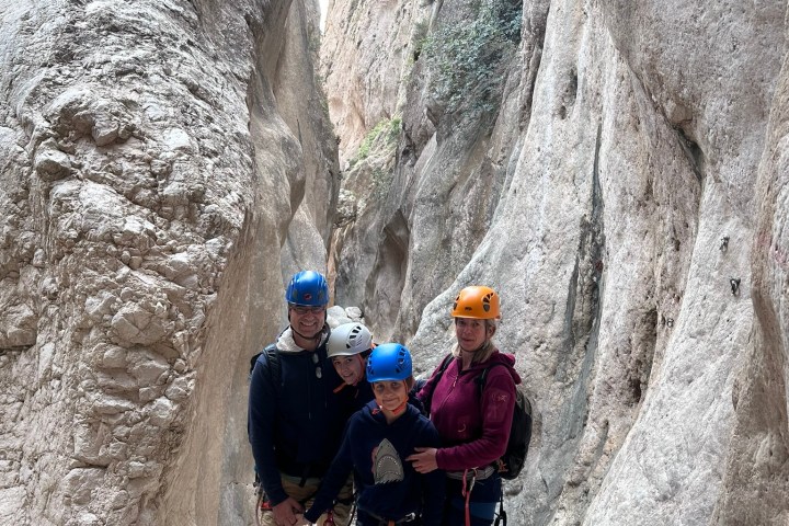 a man walking up a hill in the snow