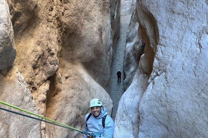 Alex Cora sitting on a rock