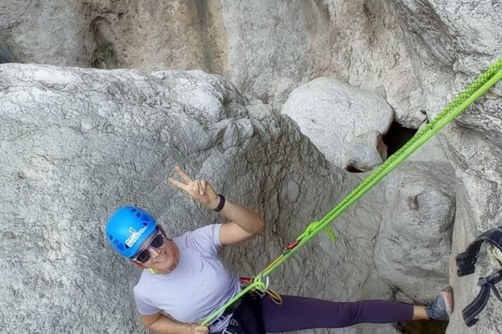 a person standing next to a stone wall
