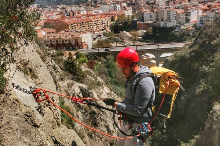 a man riding a bike down a dirt road