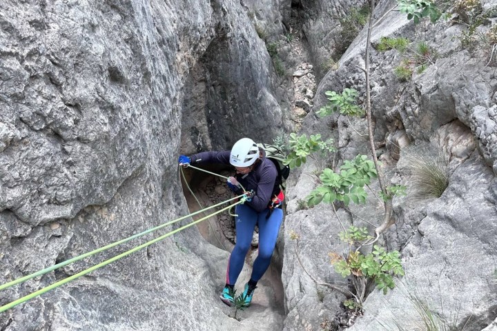 a person riding skis on top of a rock