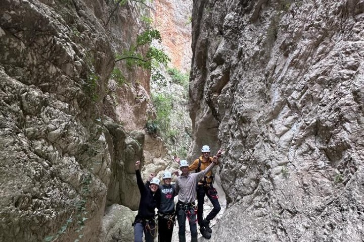a group of people standing on top of a mountain