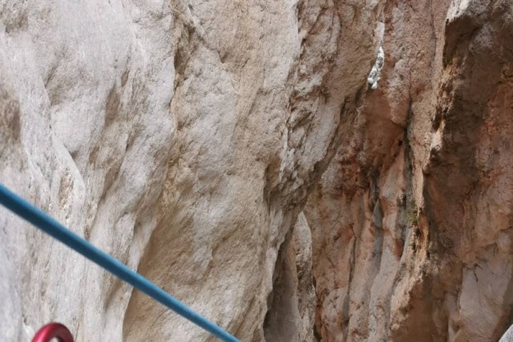 a person riding a snow board on a rock