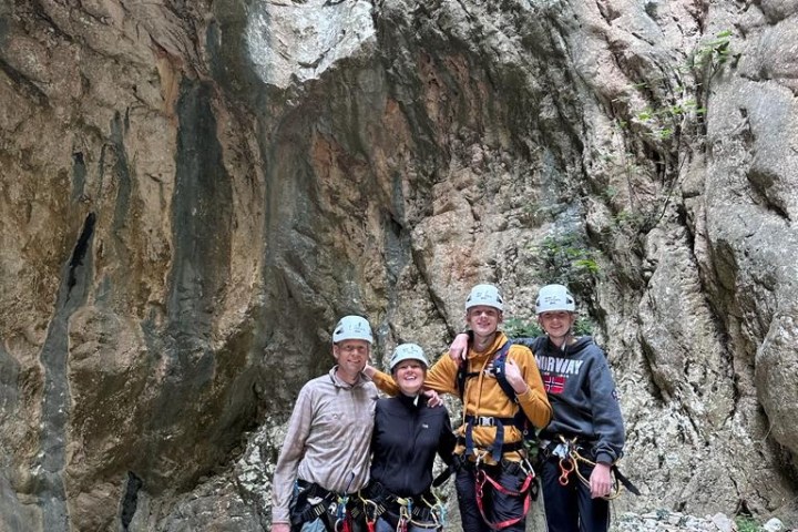 a group of people standing on a rock