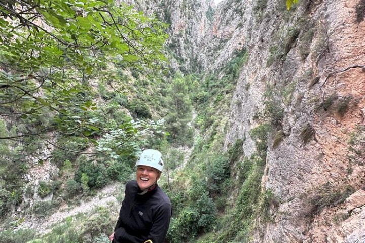 a man standing next to a tree