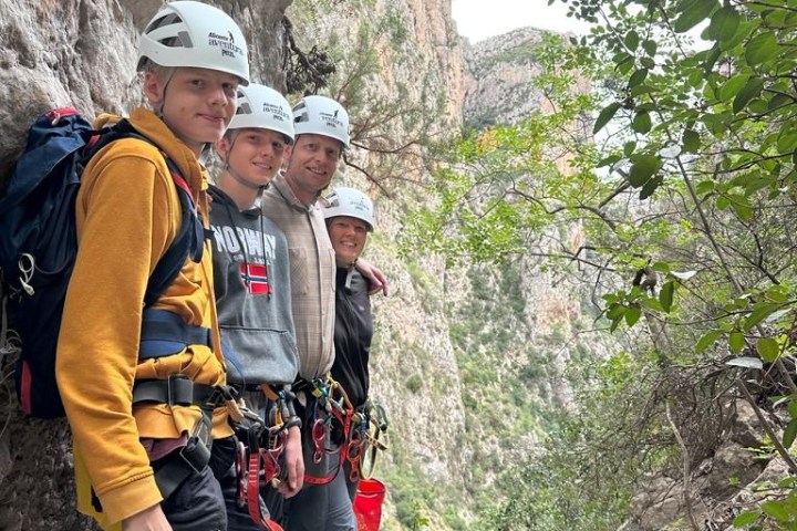 a group of people standing next to a tree