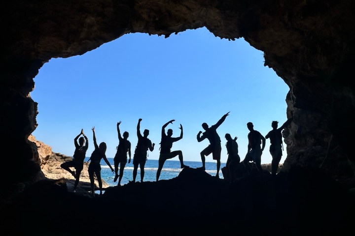 a group of people standing on top of a mountain