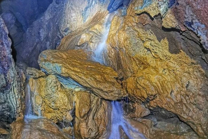 a large waterfall over a rocky cliff