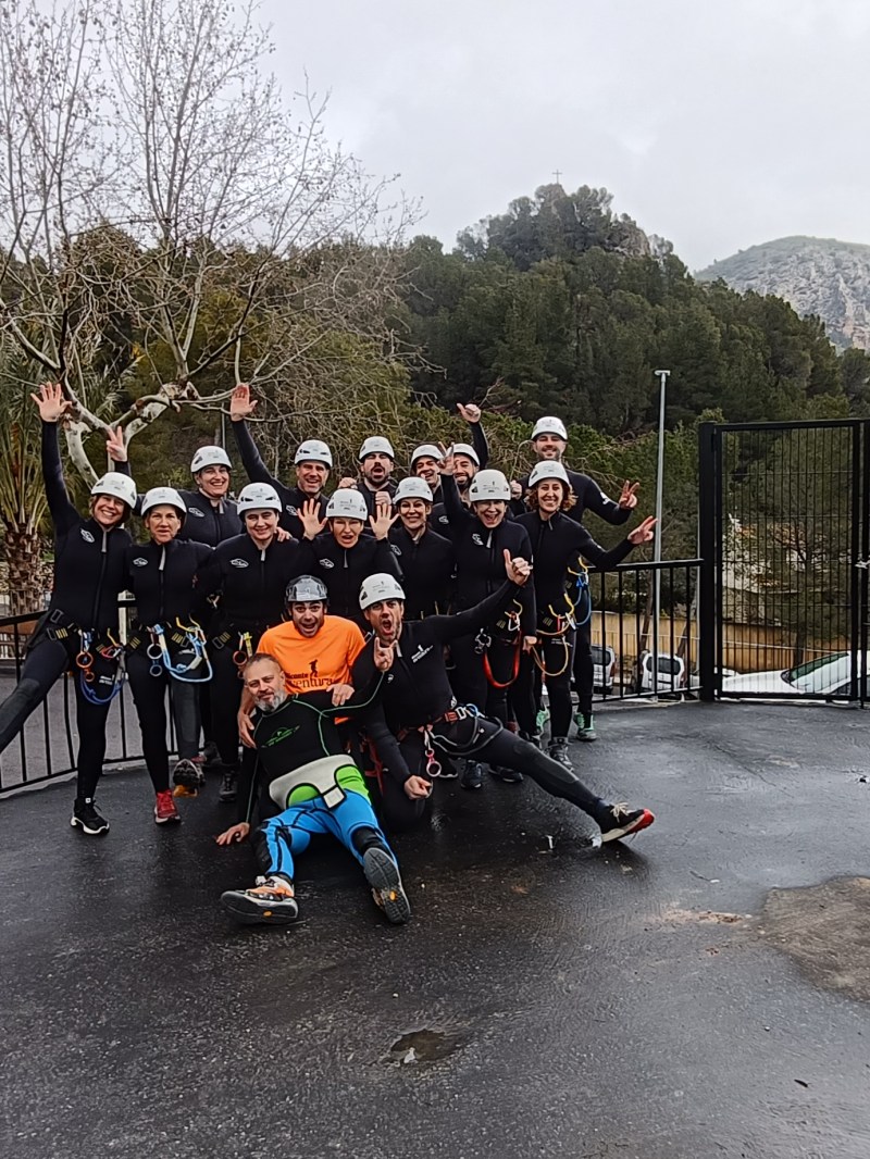 a group of people sitting on a bench in front of a mountain road