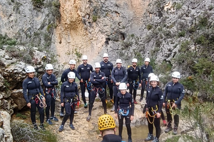 a group of people walking down a dirt road
