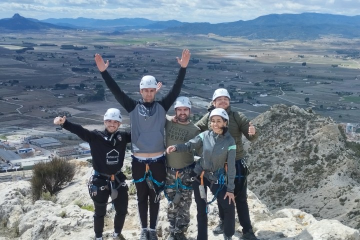 a group of people standing on top of a mountain