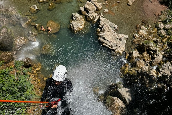 a close up of a rock next to water