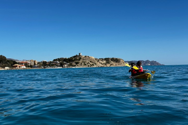 a person riding a surf board on a body of water