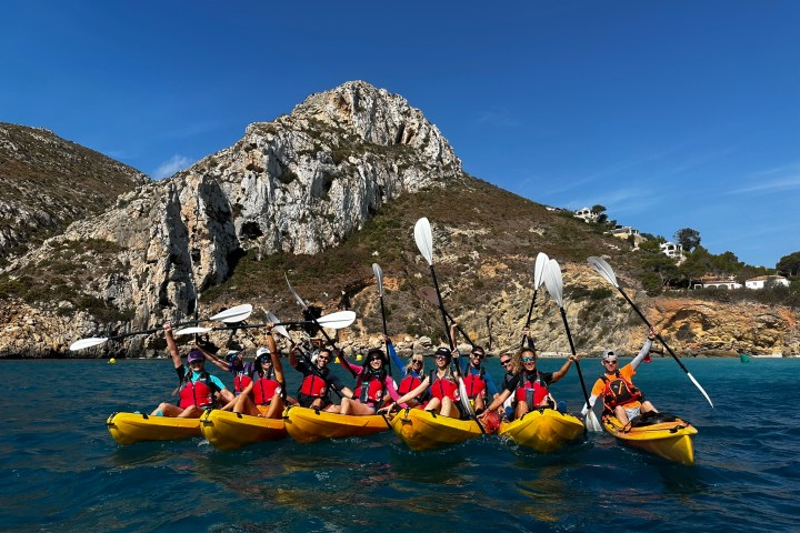 a group of people riding on the back of a boat