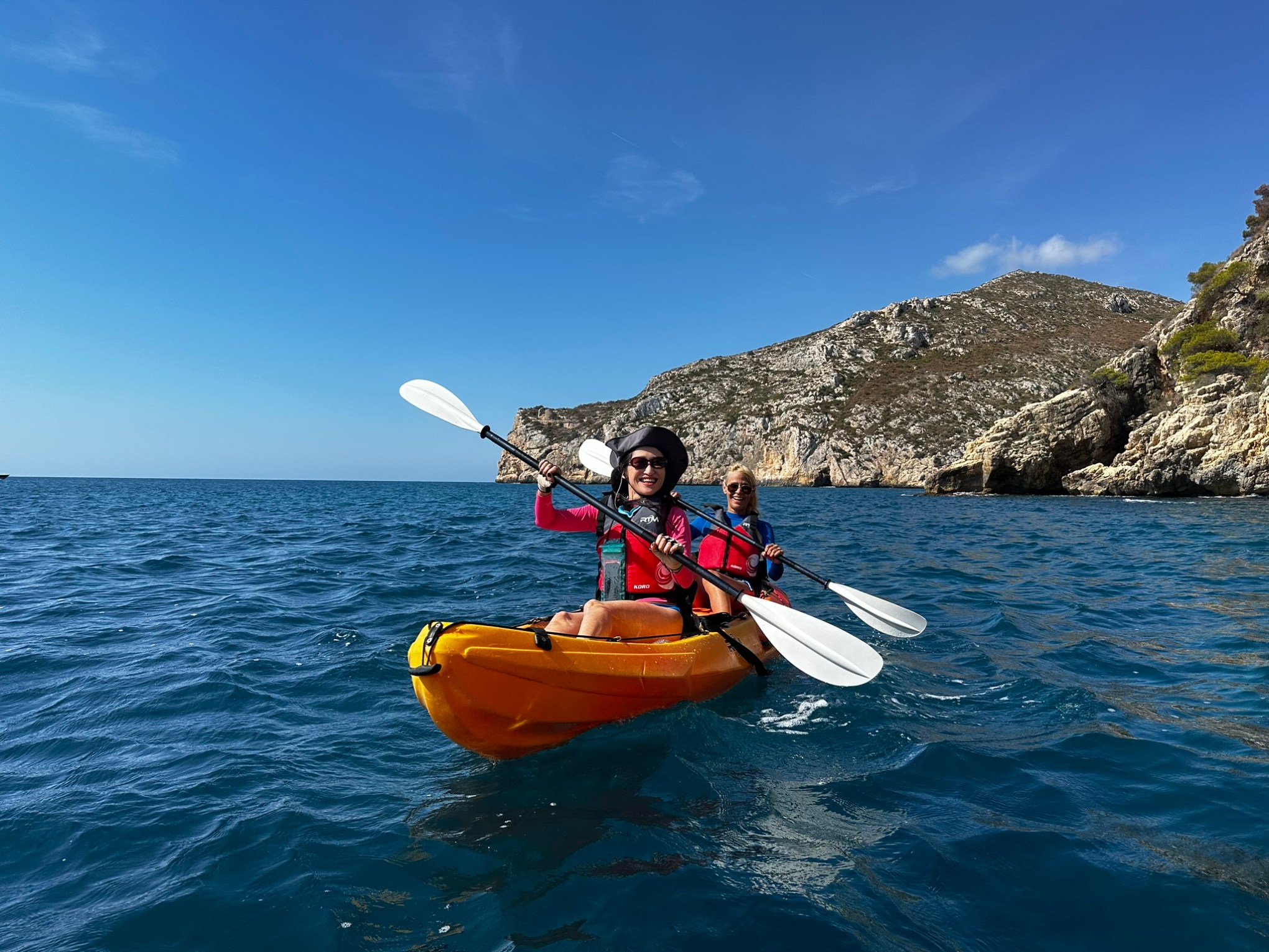 a man riding on the back of a boat in the water