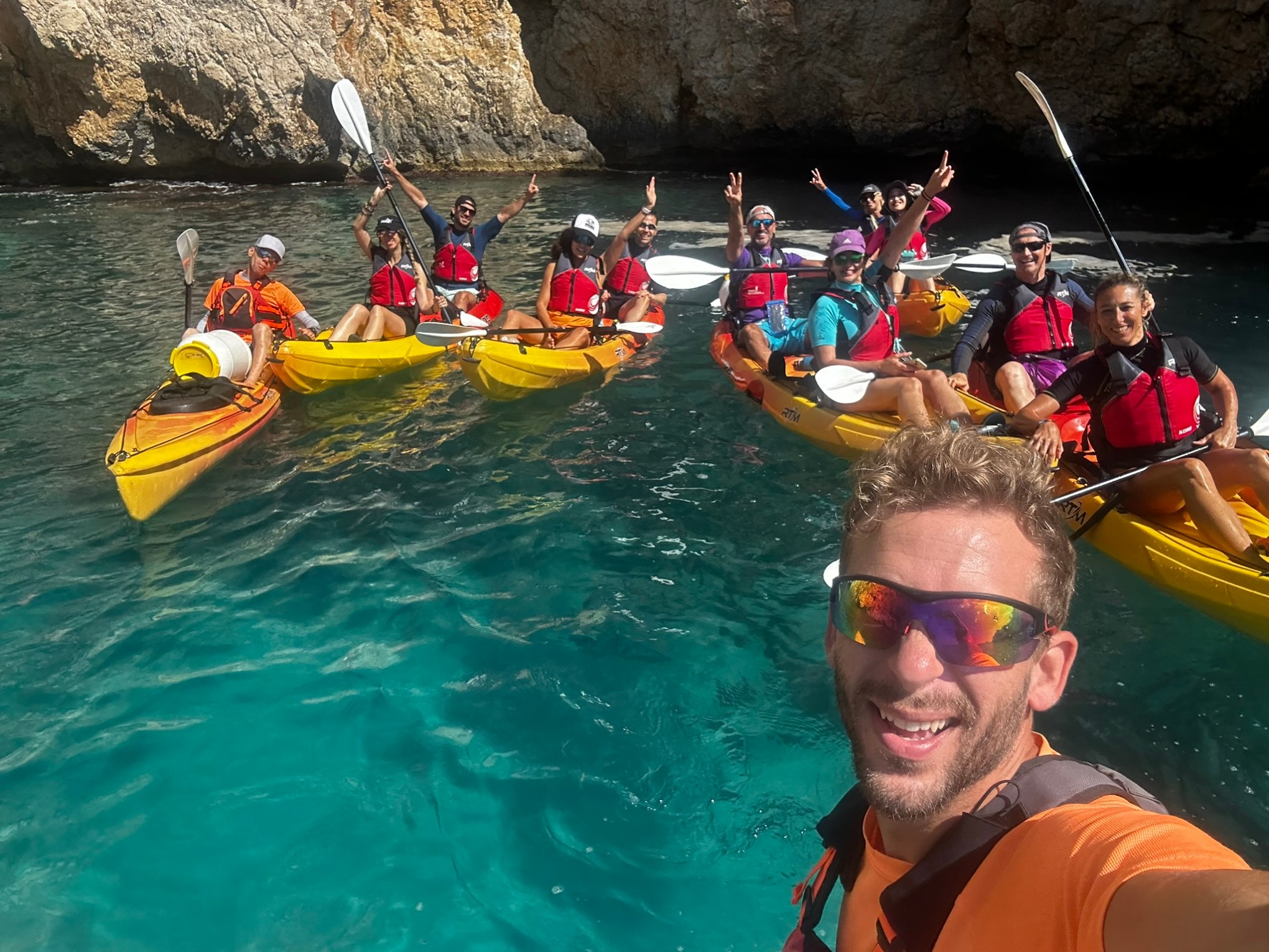 a group of people riding on the back of a boat in the water