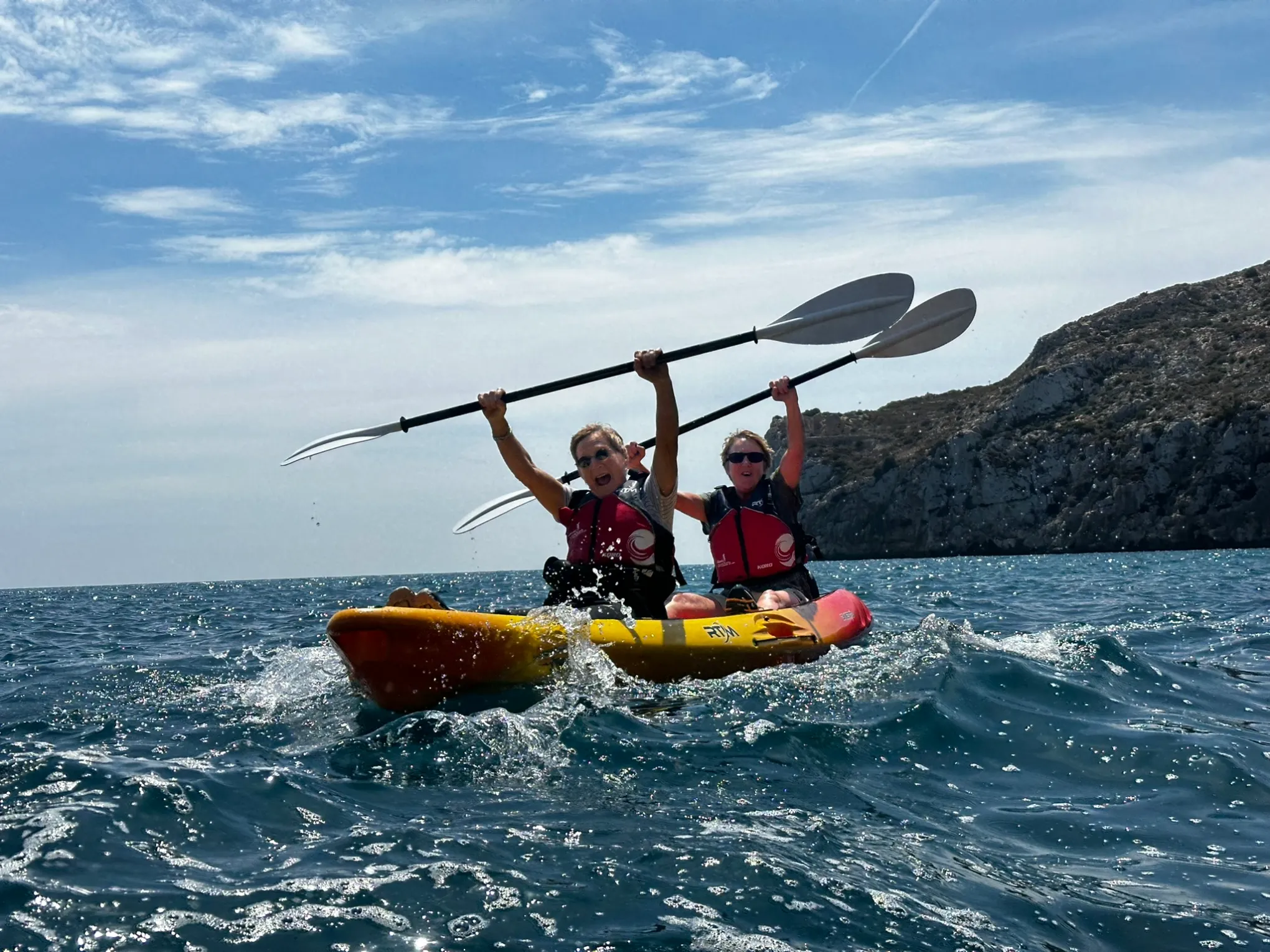 a man riding on the back of a boat in the water