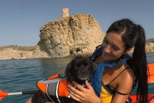 a person holding a dog in a body of water