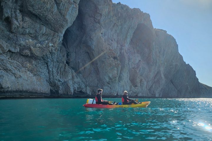 a large body of water with a mountain in the background