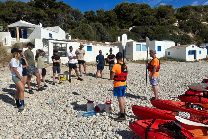 a group of people that are standing in the sand