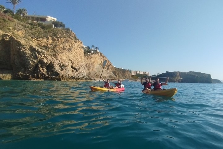 a man riding on the back of a boat in a body of water