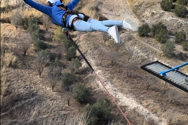 a person flying through the air while riding a bike down a dirt road