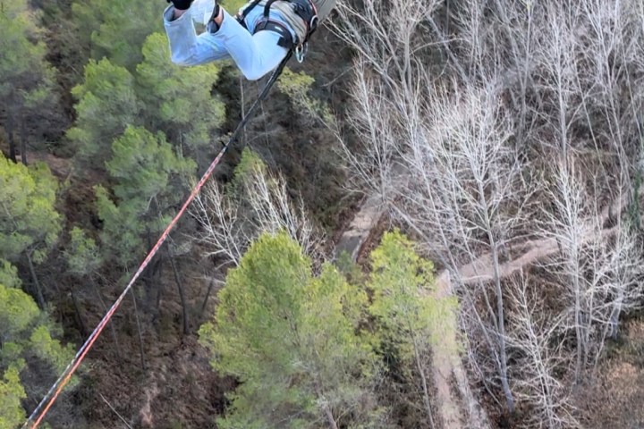 a person flying through the air on top of a mountain