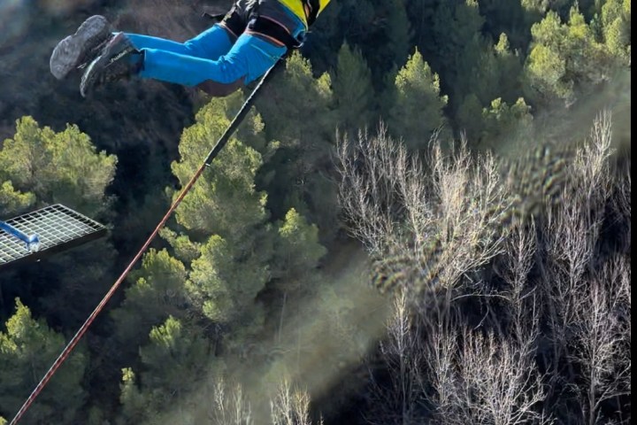 a man flying through the air while riding skis