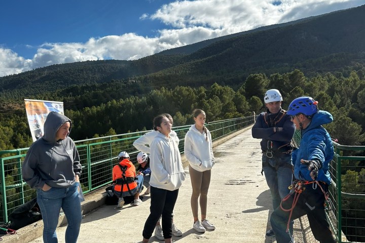 a group of people standing on top of a mountain