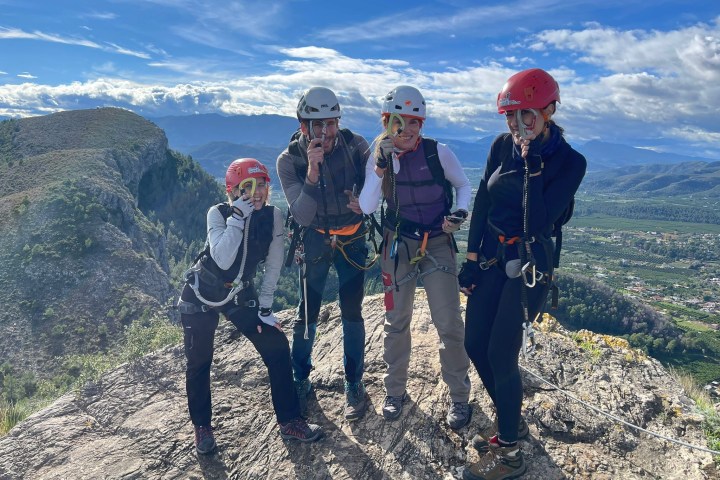 a group of people standing on top of a mountain