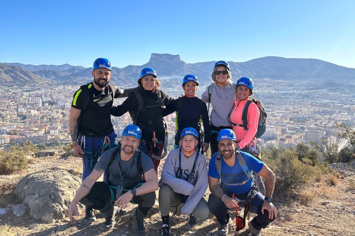 a group of people standing on top of a mountain