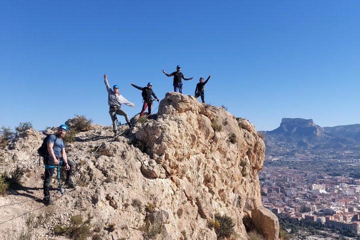 a group of people standing on a rocky hill