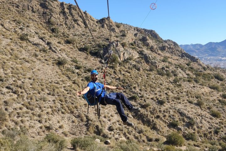 a man riding a bike down a dirt road